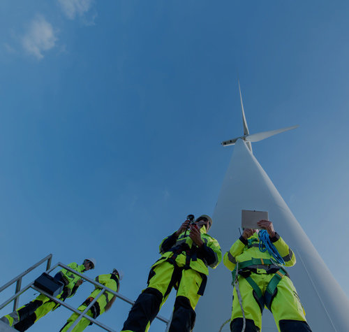 Man standing on top of a big wheel